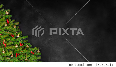 Christmas tree branches with golden baubles and red berries on dark background, festive flat lay composition with copy space for text Christmas tree branches with golden baubles and red berries on dark background, festive flat lay composition with copy space for text 132546214