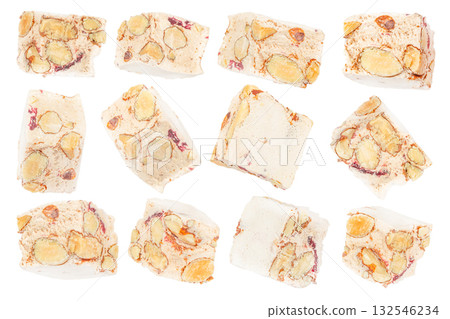 Set of traditional Italian nougat torrone pieces with almonds and dried fruits isolated on white background, festive dessert concept Set of traditional Italian nougat torrone pieces with almonds and dried fruits isolated on white background, festive dessert concept 132546234