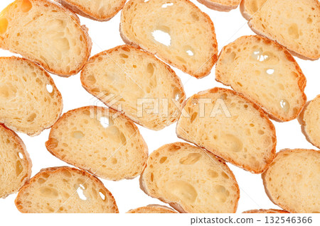 Pattern of fresh baguette bread slices on a white background. Crunchy golden crust and airy texture of traditional French bread Pattern of fresh baguette bread slices on a white background. Crunchy golden crust and airy texture of traditional French bread 132546366