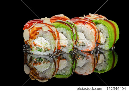 Fresh assorted sushi rolls with avocado, salmon, cream cheese, and almond slices served on a reflective black surface 132546404