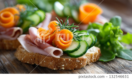 Delicious open-faced sandwich with fresh vegetables and ham on a wooden table Delicious open-faced sandwich with fresh vegetables and ham on a wooden table 132546631