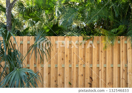 Wooden fence surrounding private property grounds for backyard protection and privacy in southern Florida Wooden fence surrounding private property grounds for backyard protection and privacy in southern Florida 132546833