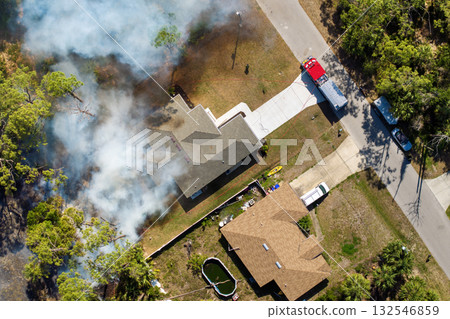 Wildfire rages near homes in Florida town while fire trucks and emergency crew combat the advancing flames Wildfire rages near homes in Florida town while fire trucks and emergency crew combat the advancing flames 132546859