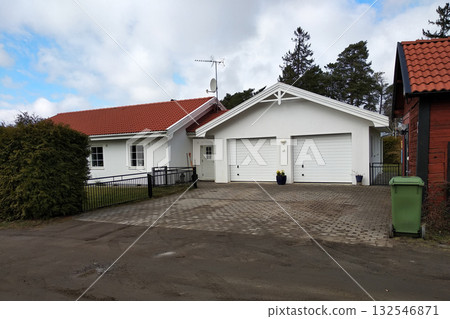 White new garage for two cars and wooden barn on private house yard. White new garage for two cars and wooden barn on private house yard. 132546871