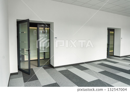 Empty office space With Two Doors and a Checkered Floor 132547004