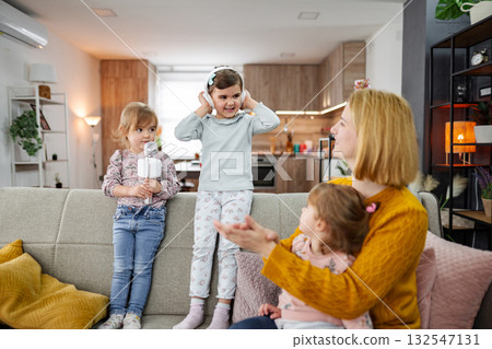 Mother and her three daughters have a karaoke party Mother and her three daughters have a karaoke party 132547131