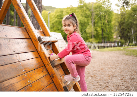 Active cute little girl on the playground 132547282