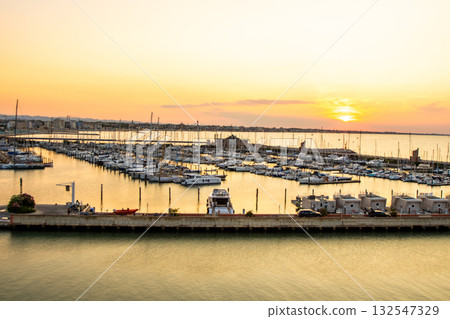 Sunset sky seaport of the Italian city of Rimini in Summer vibe. Italy Sunset sky seaport of the Italian city of Rimini in Summer vibe. Italy 132547329