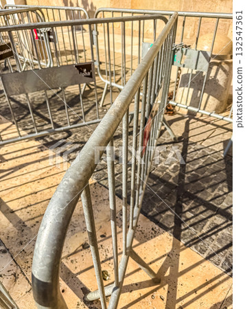 Metal Barriers on Street with Shadows in Bright Sunlight Metal Barriers on Street with Shadows in Bright Sunlight 132547361