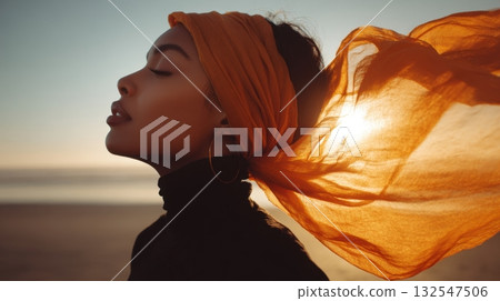 Woman enjoys sunset by the beach 132547506