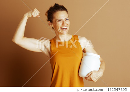 Confident Woman in Orange with Supplement 132547895