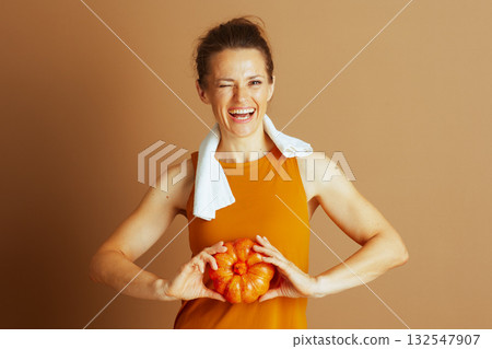 Playful Wink: Autumn Fitness with a Pumpkin Playful Wink: Autumn Fitness with a Pumpkin 132547907