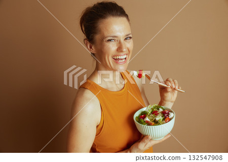 Smiling Woman with Forkful of Salad 132547908
