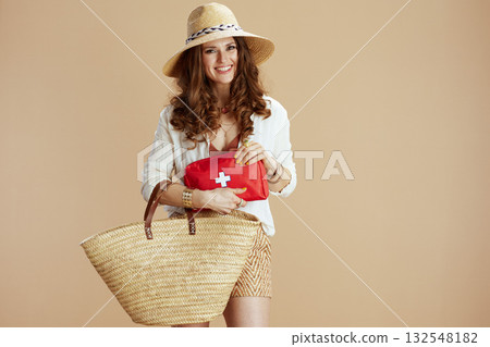 happy woman in blouse and shorts against beige happy woman in blouse and shorts against beige 132548182