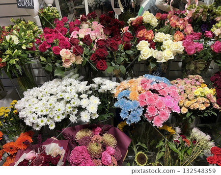 Colorful assortment of fresh flowers including roses, daisies, and carnations arranged beautifully in a floral shop, showcasing vibrant hues and natural beauty for decoration or gifting Colorful assortment of fresh flowers including roses, daisies, and carnations arranged beautifully in a floral shop, showcasing vibrant hues and natural beauty for decoration or gifting 132548359
