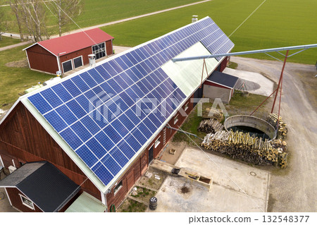 Top view of blue solar photo voltaic panels system on wooden building, barn or house roof. Renewable ecological green energy production concept. 132548377