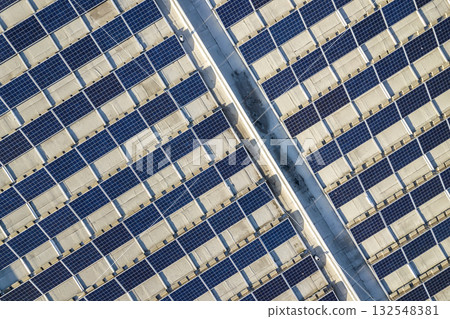 Top view of blue shiny solar photo voltaic panels system producing renewable clean energy abstract background. 132548381