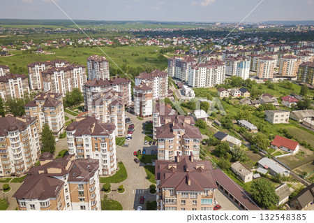 Top view of apartment or office tall buildings, parked cars, urban city landscape. Drone aerial photography. 132548385