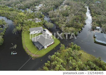 Surrounded by hurricane Ian rainfall flood waters homes in Florida residential area. Aftermath of natural disaster Surrounded by hurricane Ian rainfall flood waters homes in Florida residential area. Aftermath of natural disaster 132548405