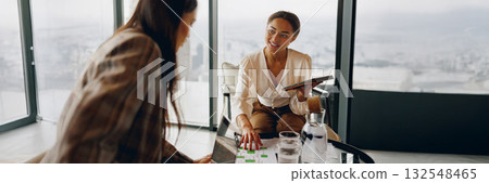 A Collaborative Business Meeting Taking Place in a Modern Office Space Environment 132548465