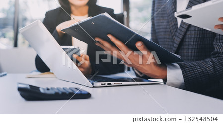 Accounting company provide finance and taxation planning for profitable cash flow, Auditor and accountant team working in office, analyze financial data and accounting record with calculator.Insight Accounting company provide finance and taxation planning for profitable cash flow, Auditor and accountant team working in office, analyze financial data and accounting record with calculator.Insight 132548504