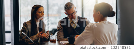 Business meeting in a cozy cafe atmosphere enhances productivity and collaboration Business meeting in a cozy cafe atmosphere enhances productivity and collaboration 132548581