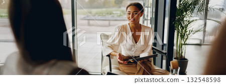 Professional Meeting Taking Place in a Modern Office Setting Focused on Collaboration and Success Professional Meeting Taking Place in a Modern Office Setting Focused on Collaboration and Success 132548598