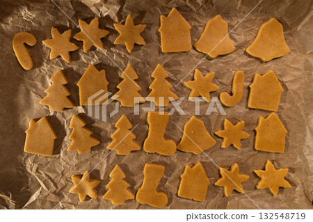 Raw Gingerbread Dough Cutouts Ready for Baking on Parchment Raw Gingerbread Dough Cutouts Ready for Baking on Parchment 132548719
