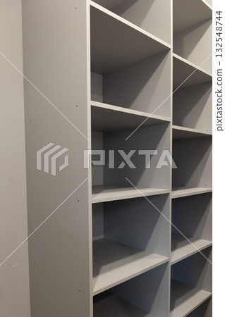 Gray Wooden Shelving Unit With Multiple Empty Shelves Stands Tall Gray Wooden Shelving Unit With Multiple Empty Shelves Stands Tall 132548744