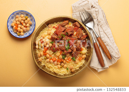 Moroccan couscous with tender meat and chickpea stew in rustic bow top view, Maghreb cuisine 132548833