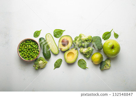 Fresh green vegetables and fruit white background top view, diet, vegetarian healthy food 132548847