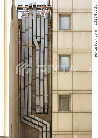metal collectors on the facade of a building 132549526
