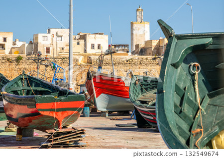 Old port with wooden boats and fortress walls, El Jadida, Morocco 132549674