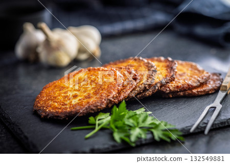 Fried potato pancake on black table. Fried potato pancake on black table. 132549881