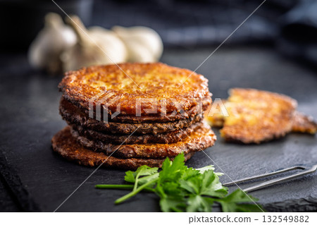 Fried potato pancake on black table. Fried potato pancake on black table. 132549882