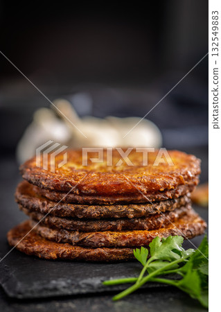 Fried potato pancake on black table. Fried potato pancake on black table. 132549883