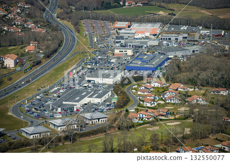 Shopping complex and surrounding area captured from above in daytime Shopping complex and surrounding area captured from above in daytime 132550077