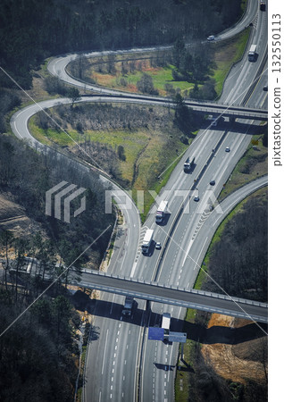 Breathtaking view of winding highways and trucks on a sunny day Breathtaking view of winding highways and trucks on a sunny day 132550113