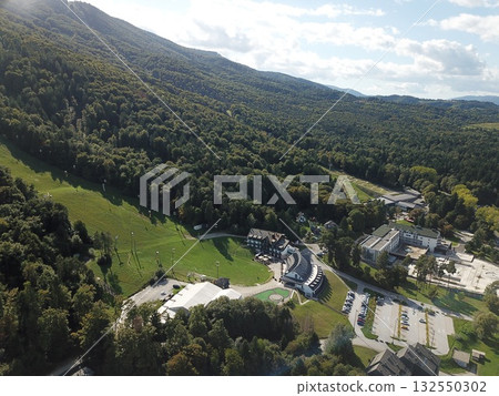 Pohorje mountain ski resort aerial view over buildings and green slopes in Maribor, Slovenia during summer 132550302