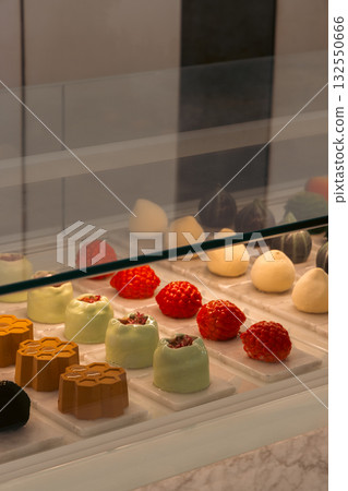 A beautifully arranged assorted gourmet chocolate display showcased in a lovely pastry shop A beautifully arranged assorted gourmet chocolate display showcased in a lovely pastry shop 132550666