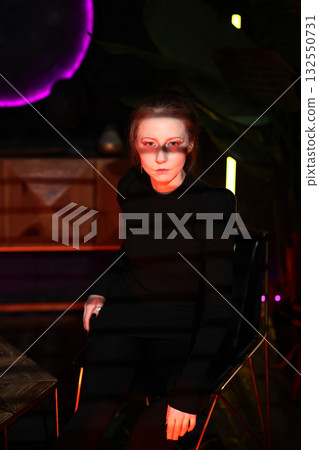 woman consulting privately, seated woman engaged in private consultation with glasses catching 132550731