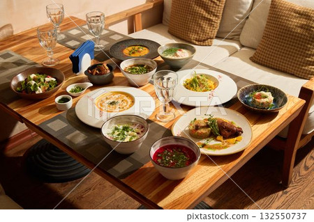 Indulge in a Delicious Multicultural Feast Spread Across a Beautiful Rustic Table Setting Indulge in a Delicious Multicultural Feast Spread Across a Beautiful Rustic Table Setting 132550737