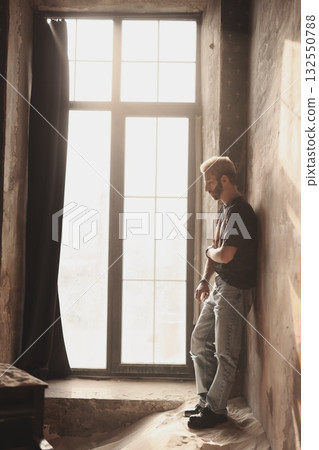 A Contemporary Man Posing Gracefully in a Brightly Lit Industrial Space Full of Character 132550788