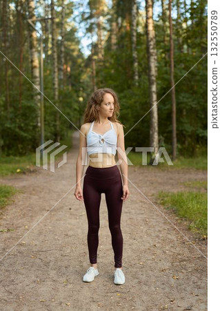 Fitness Enthusiast in Nature Standing Strong Amongst the Trees and Embracing the Outdoors 132550789
