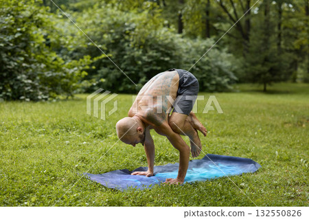Engaging in the Practice of Yoga Pose Surrounded by the Beauty of Nature Outdoors 132550826
