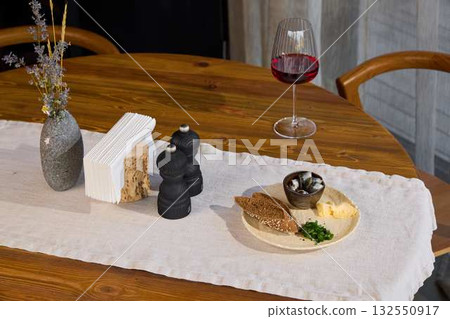 An Elegant Dining Setting Enhanced with Wine and Assorted Delicious Appetizers for Enjoyment An Elegant Dining Setting Enhanced with Wine and Assorted Delicious Appetizers for Enjoyment 132550917