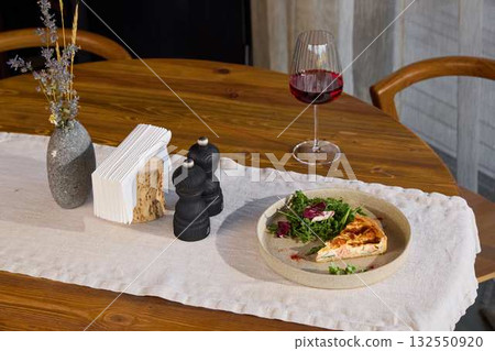 Elegant and Beautiful Dining Table Setup Featuring a Gourmet Dish Accompanied by Wine 132550920