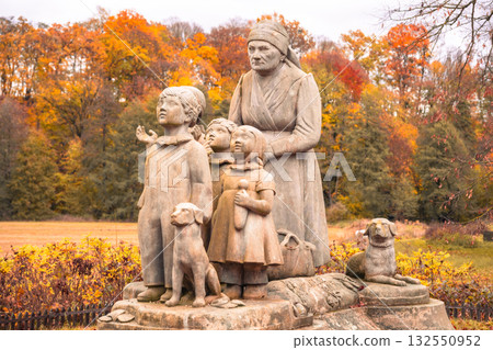 This beautiful statue in Granny Valley shows a grandmother with her three grandchildren, surrounded by autumn foliage. The artwork honors Czech writer Bozena Nemcova's legacy. 132550952