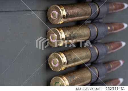 .50 BMG caliber machine gun ammunition belt with cartridges in ammunition can. 132551481