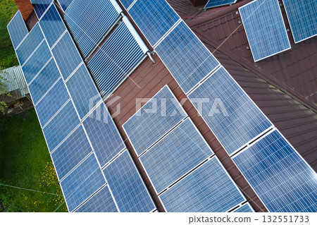 Private home roof covered with solar photovoltaic panels for generating of clean ecological electric energy in suburban rural town area. Concept of autonomous house 132551733